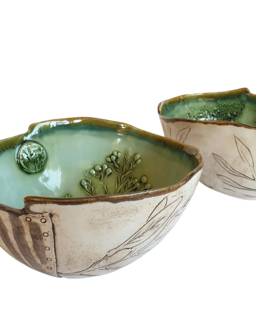 Two bowls with leaf impressions under a green glaze, rims cut and notched